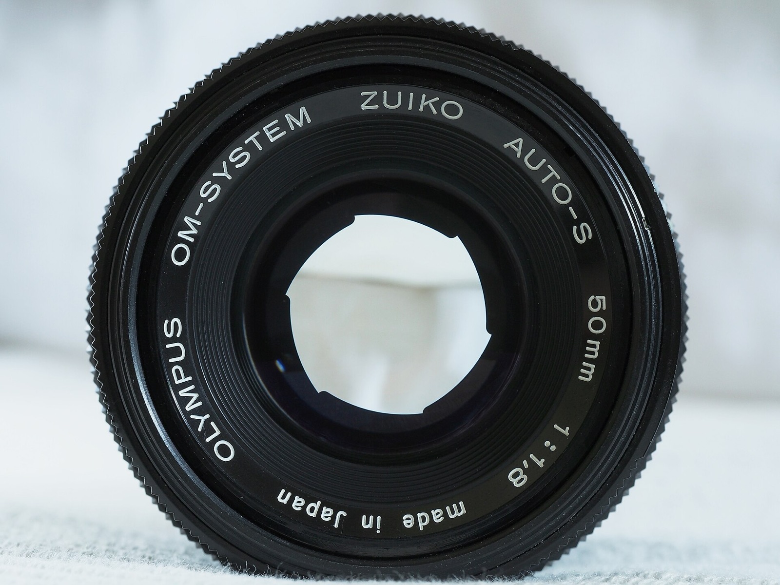 Front of a 50 mm lens with six aperture blades partly closed to form a hexagonal opening