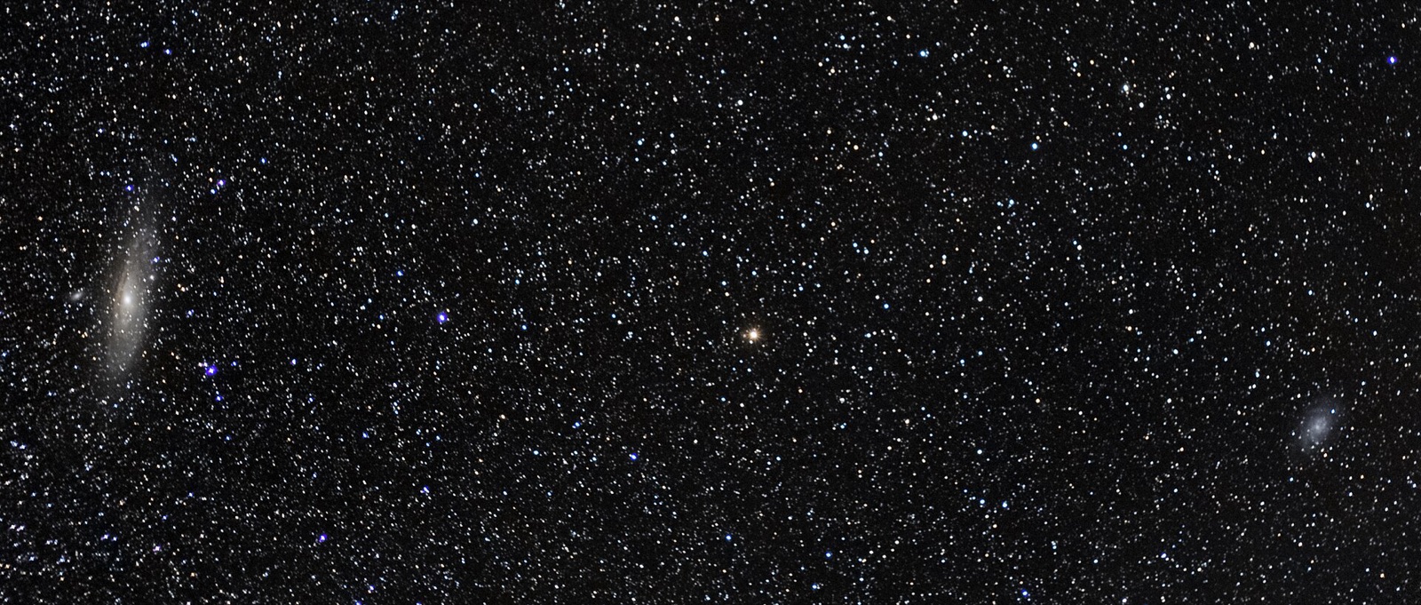 Wide star field with the Andromeda and Triangulum galaxies, photographed with a 50 mm lens