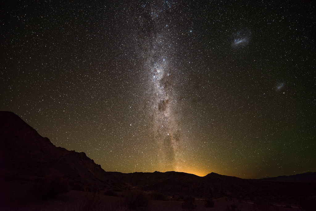 Milky Way standing above a dark desert ridge, photographed with a 14 mm lens