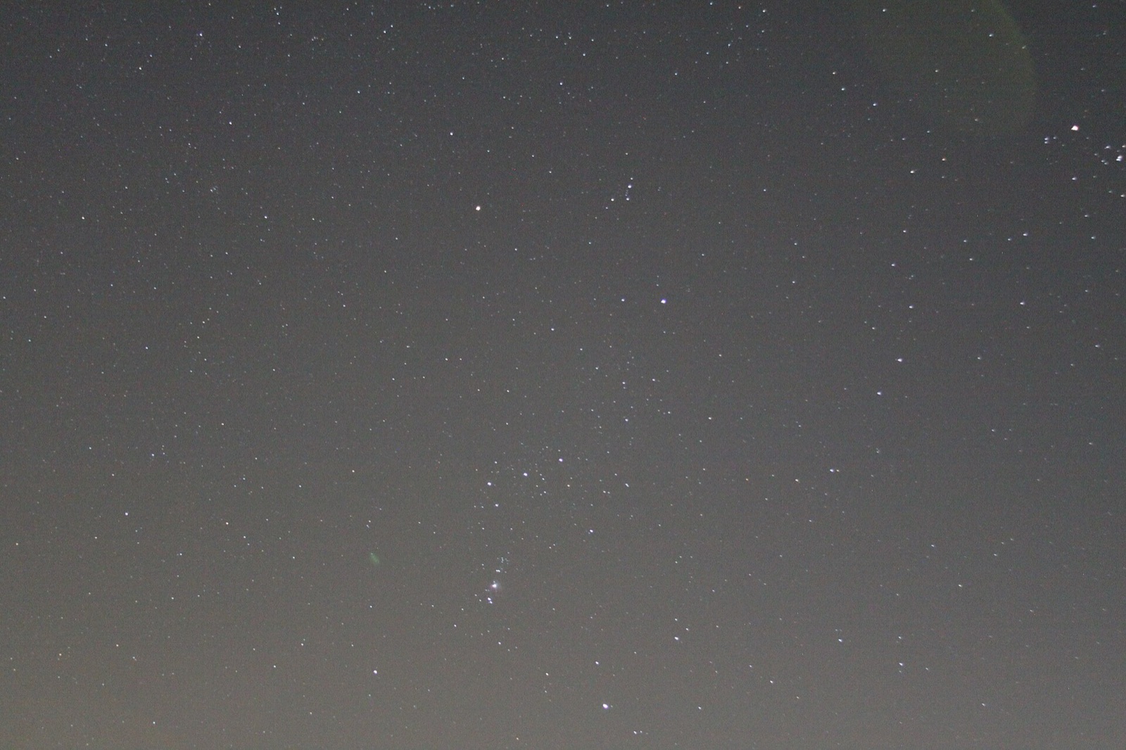 Orion and Aldebaran in a pale, light-polluted night sky from a single 13 second exposure