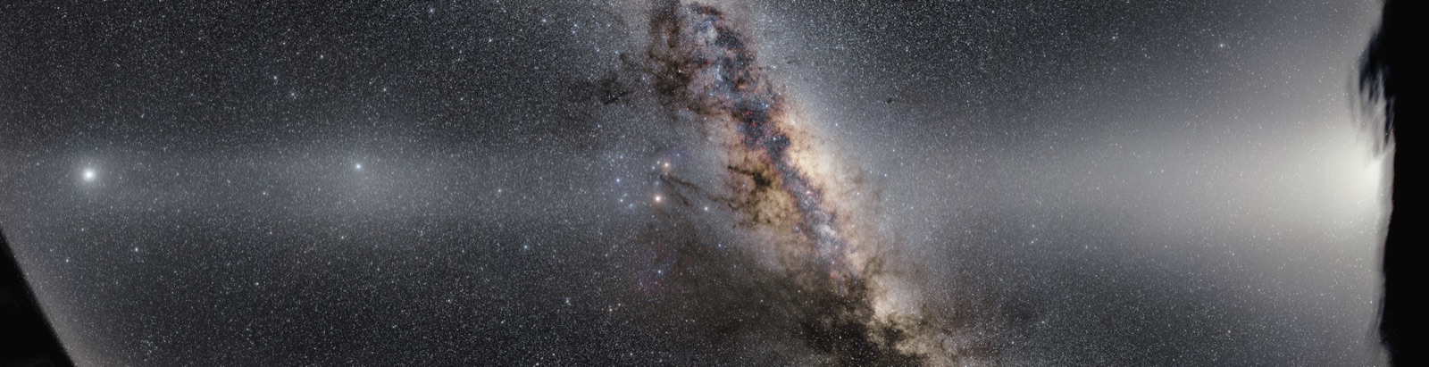 Wide panorama of the Milky Way core with a band of zodiacal light crossing it